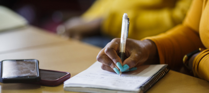 person writing in a notebook