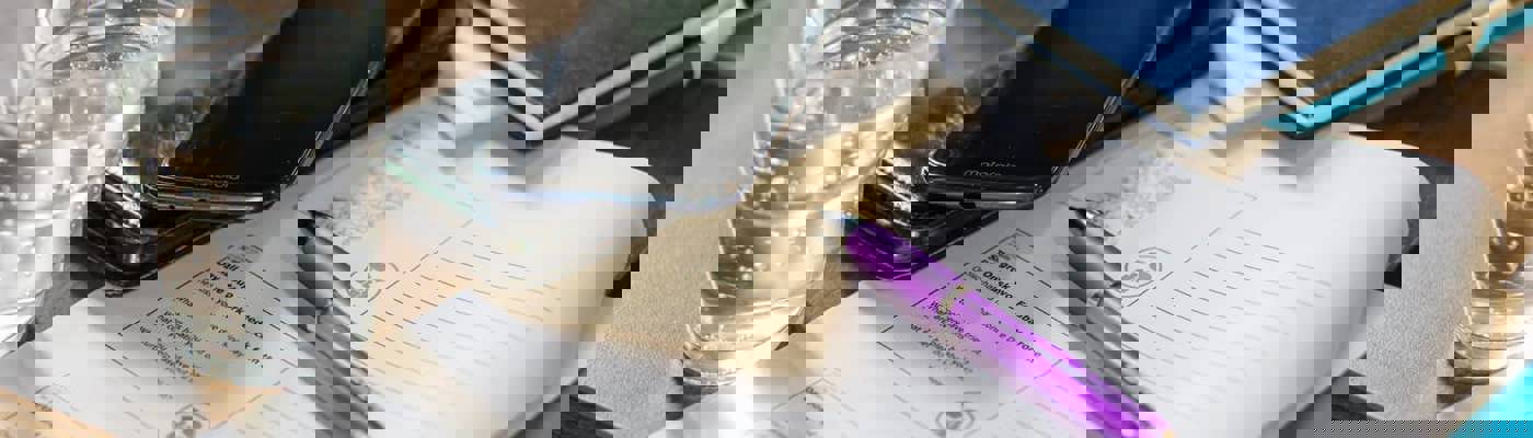 mobile phone and papers on a table